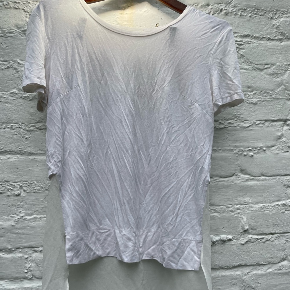 Cute white t shirt with blouse like detailing on back bottom